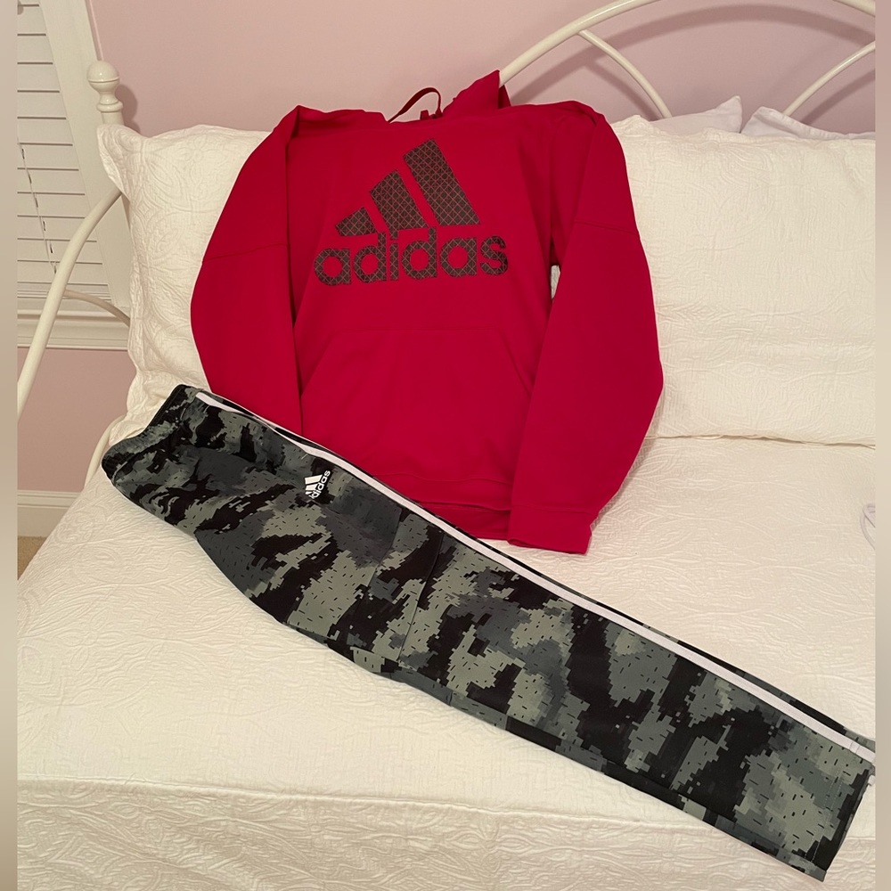 Adidas hoodie and Tiro track pants.